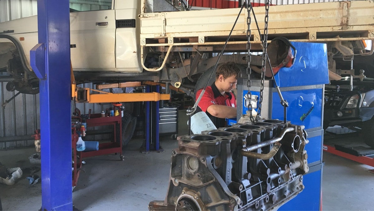 Reconditioned engine raised on hoist ready for installation at Maranoa Mechanical workshop